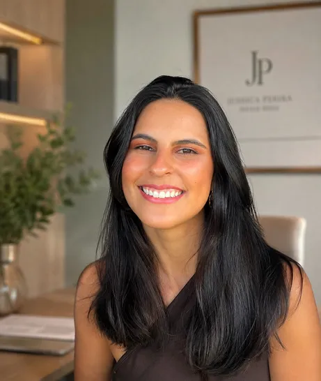 Janaina Pereira sorrindo em seu consultório de nutrição